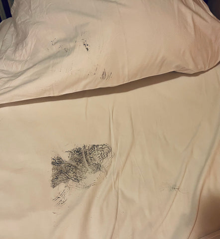 Bedsheets stained by tattoo ink