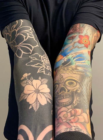 Negative space blackout sleeve tattoos in Germnay