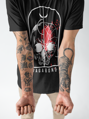 man with tattooed arms wearing black front print mens vagabond t-shirt
