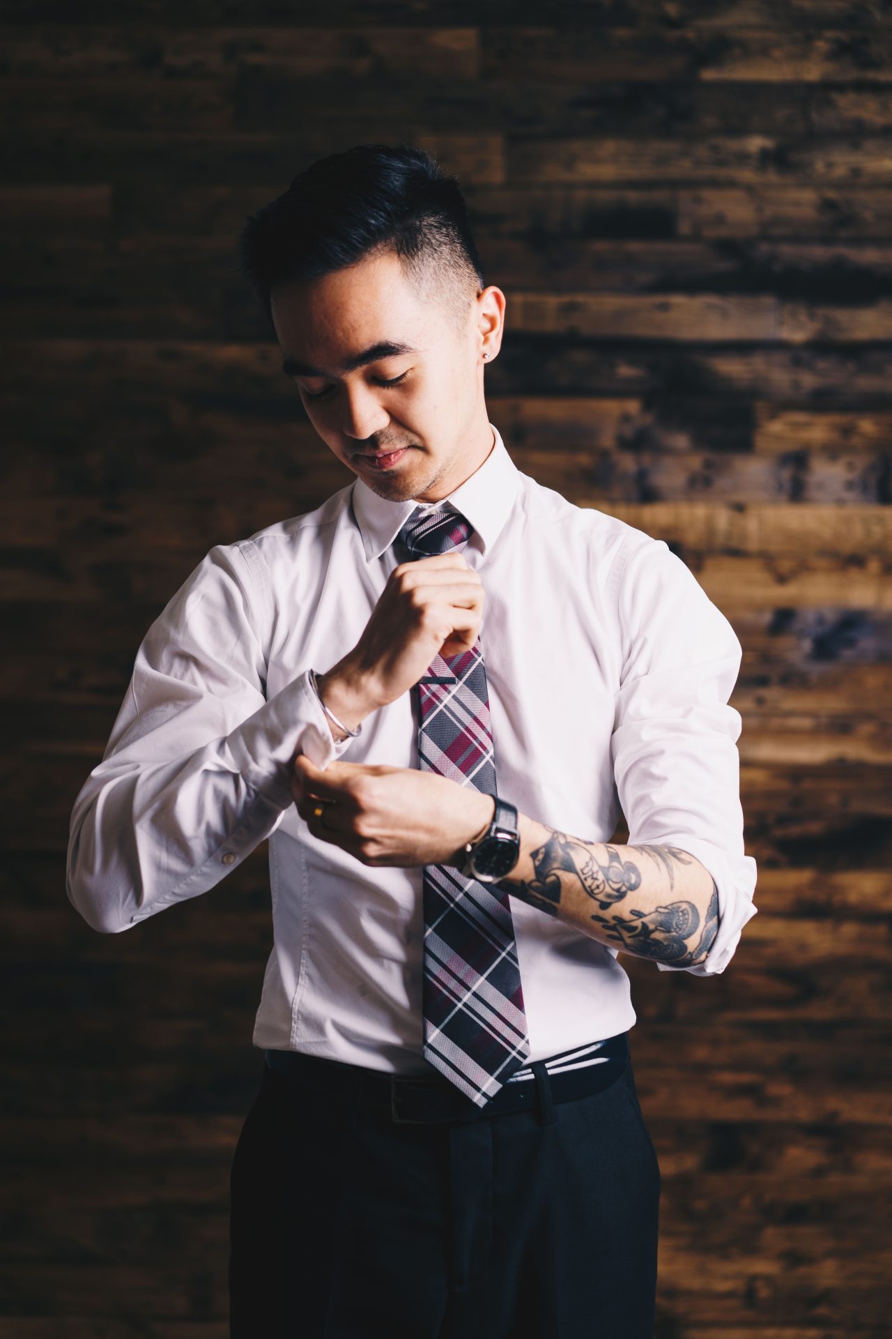 man with tattoos in a suit